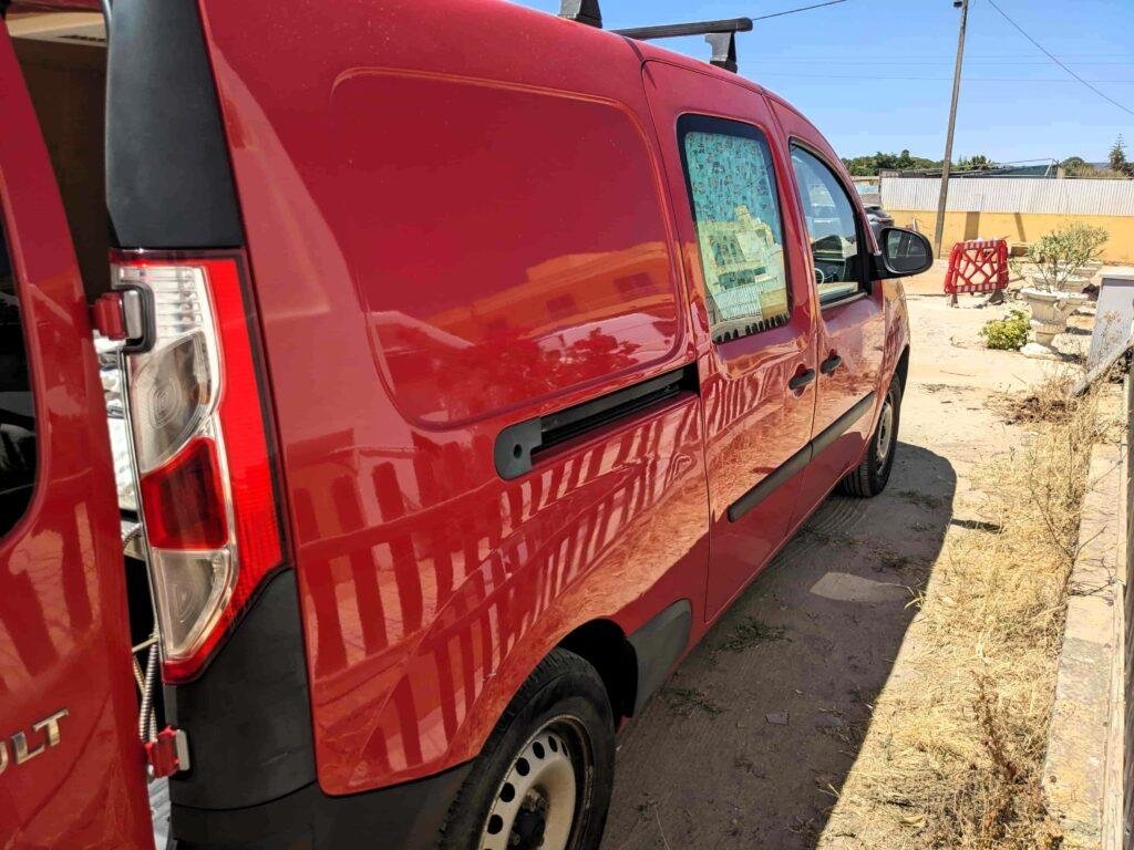 Sliding side door of the red mini campervan