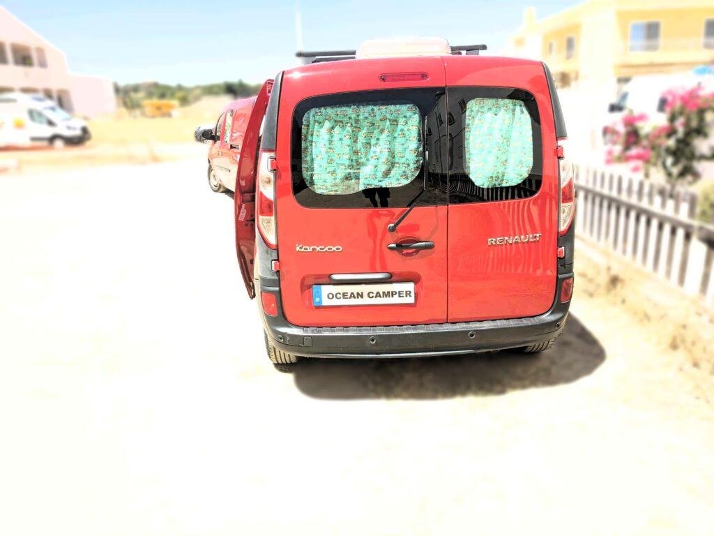 Rear of the red Renault Kangoo Maxi XXL mini campervan with window curtains